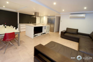 Modern kitchen and living area with sleek furniture and appliances.